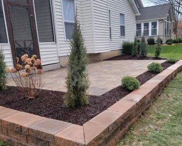 Retaining wall surrounding a functional paver patio