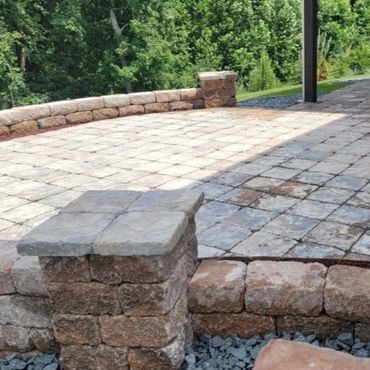 Retaining wall surrounding a functional paver patio