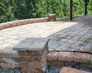 Retaining wall surrounding a functional paver patio