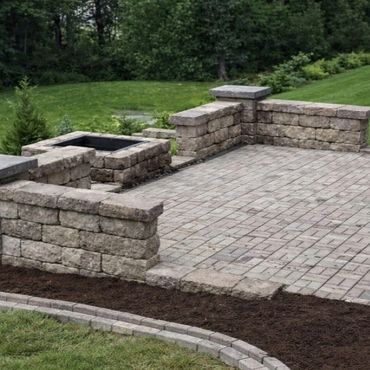 Retaining wall surrounding a functional paver patio