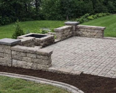 Retaining wall surrounding a functional paver patio