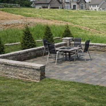 Retaining wall surrounding a functional paver patio