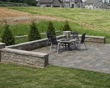 Retaining wall surrounding a functional paver patio