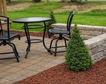 Retaining wall surrounding a functional paver patio