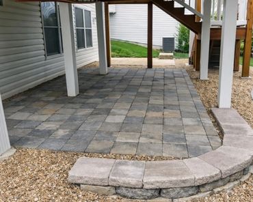 Functional paver patio under a deck