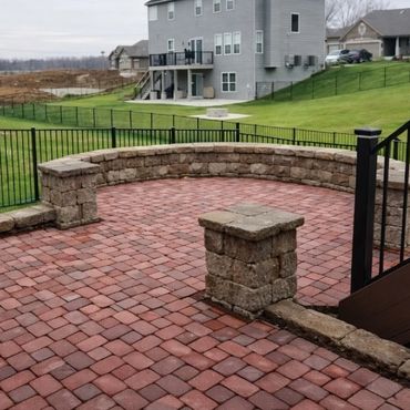Retaining wall surrounding a functional paver patio