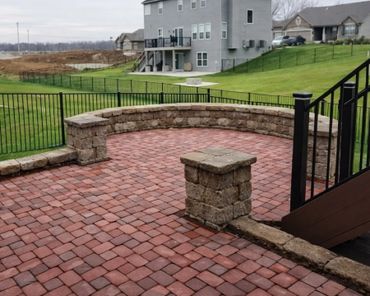 Retaining wall surrounding a functional paver patio