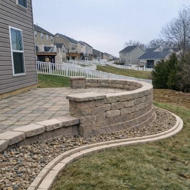Retaining wall surrounding a functional paver patio