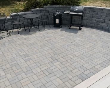 Retaining wall surrounding a functional paver patio