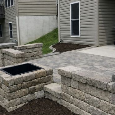 Retaining wall surrounding a functional paver patio