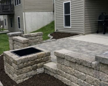 Retaining wall surrounding a functional paver patio