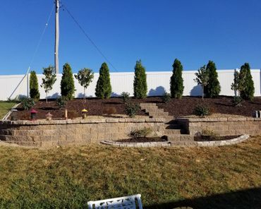 Aesthetic retaining wall, brick edging, and shrubs