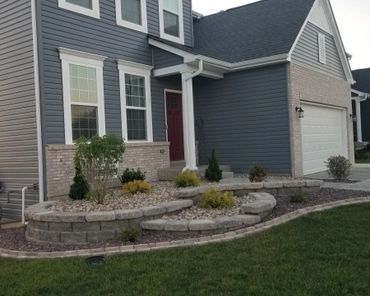 Aesthetic retaining wall, brick edging, and shrubs