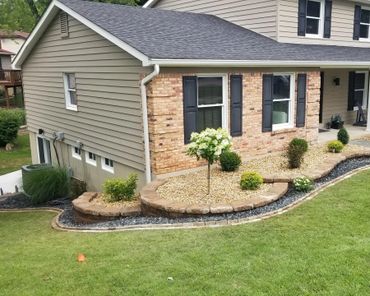 Aesthetic retaining wall, brick edging, and shrubs