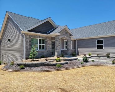 Aesthetic retaining wall, brick edging, and shrubs