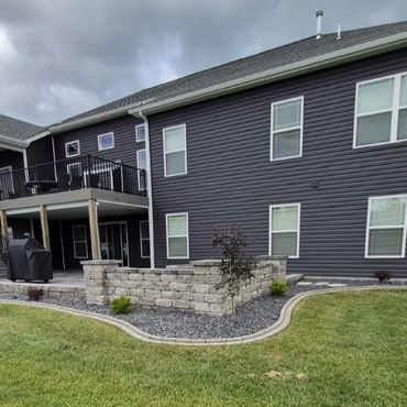 Modern home with a stone retaining wall.