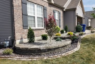 Retaining Wall, edging, and plantings designed and installed by Classic Landscape