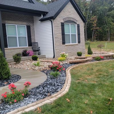 Retaining walls, edging, flowering shrubs and decorative rock