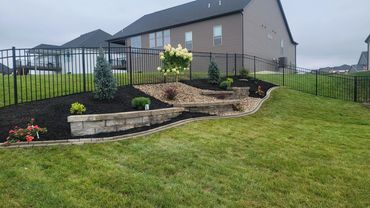 Retaining Wall, edging, and plantings designed and installed by Classic Landscape