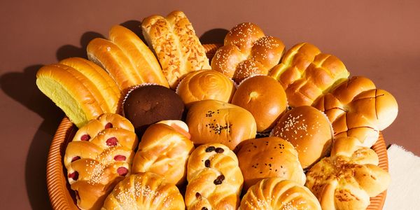 A large platter of assorted freshly baked breads and pastries.