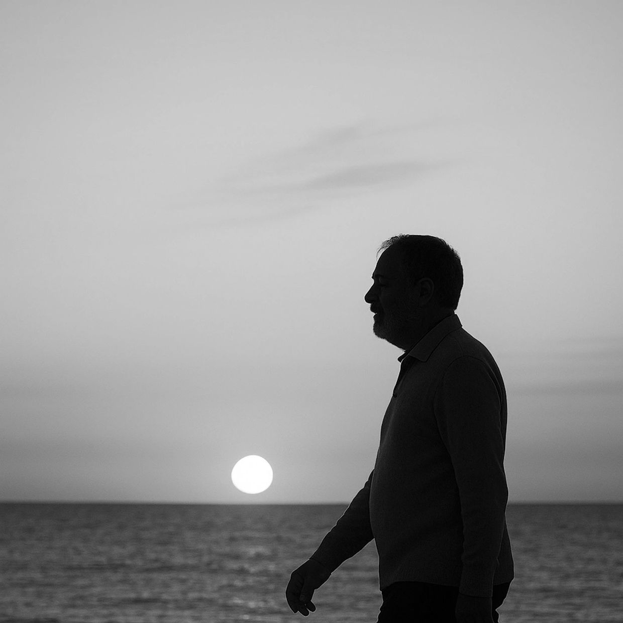 Kyle walking on the beach at sunrise.