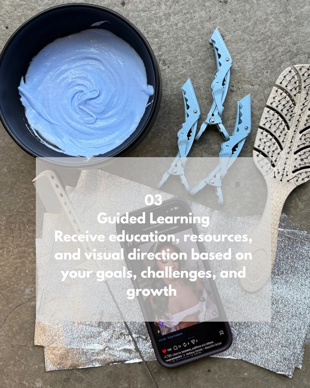 Hair styling tools and a phone with educational content for guided learning.