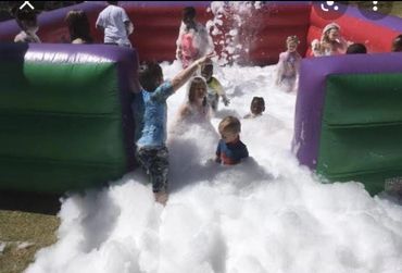 Inflatable foam pit with children and foam