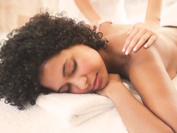 A woman receiving a relaxing back massage.