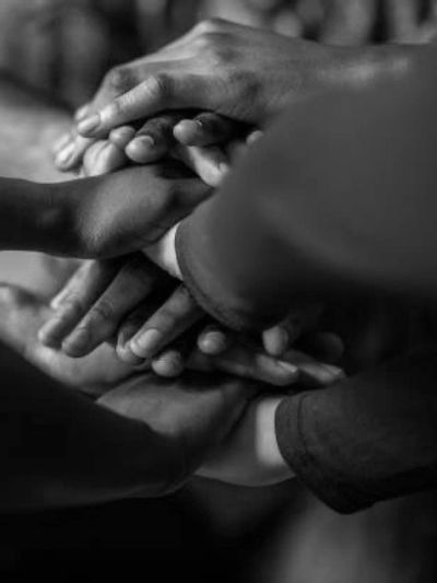 Multiple hands huddle