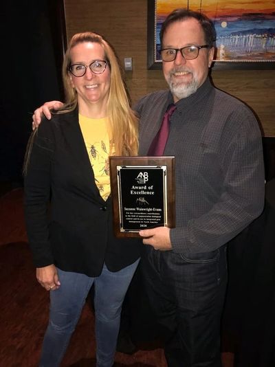 Suzanne Wainwright-Evans receiving ANBP award of excellence from Casey Decker. 