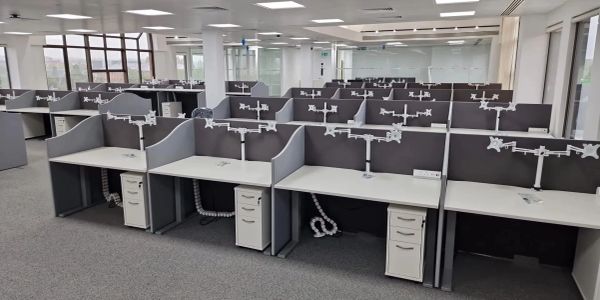 Empty modern office cubicles with monitors mounts.