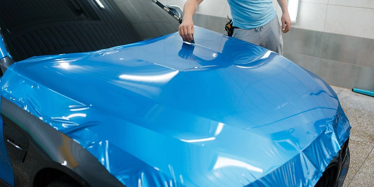 Blue vehicle vinyl wrap installation
