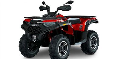 Red and black all-terrain ATV with large rugged tires and rear cargo rack.