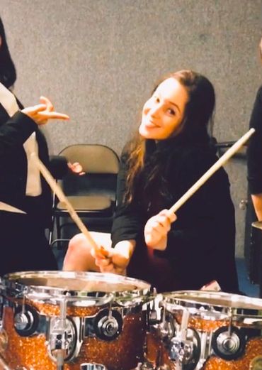 A woman playing drums