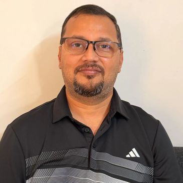 Man wearing glasses and a black Adidas shirt.