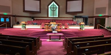 Interior of a church sanctuary with pews and a pulpit.