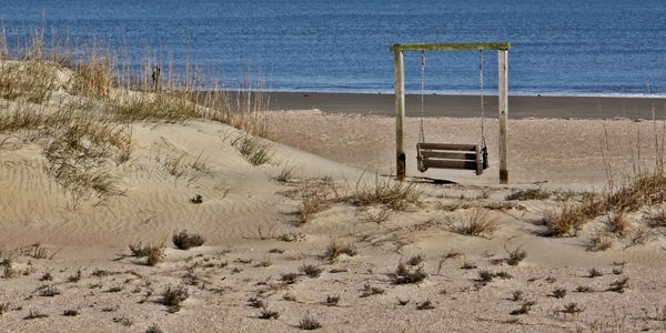 Lone swing on beach in Charleston, SC.