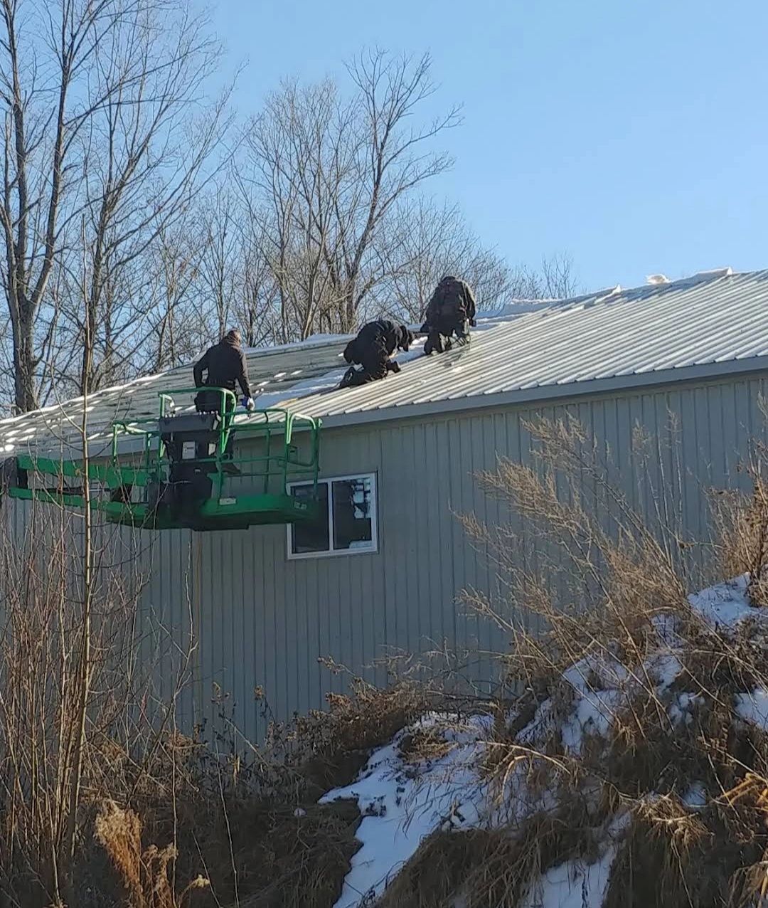 The team installing a metal roof