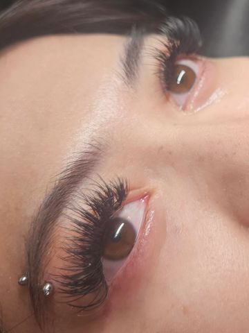 A pair of eyes,showing a Fullset of UV light lashes, D curl