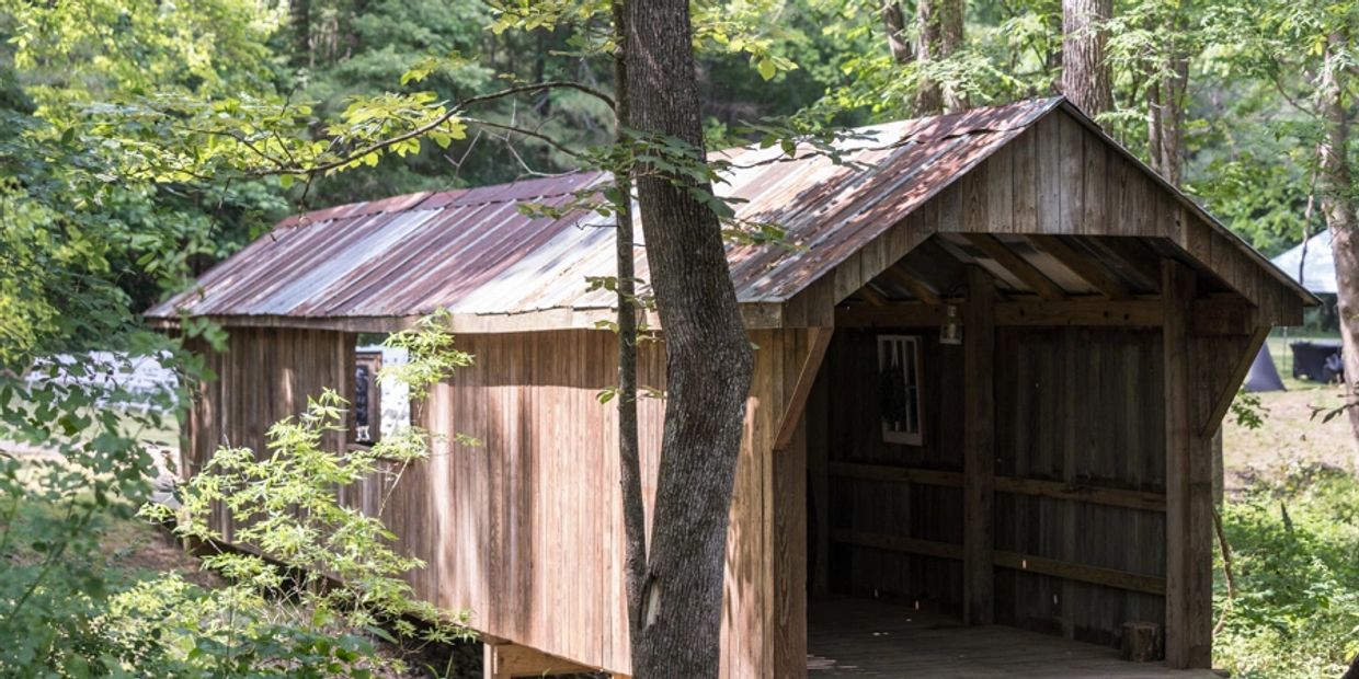 Enchanting Covered Bridge that leads to the ceremony area. 