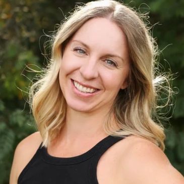 Smiling blond woman outdoors.