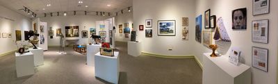 Art gallery showcasing diverse paintings and sculptures.