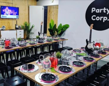 Modern party setup with electric guitars as decor.