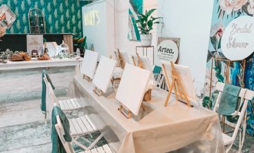 Art easels and blank canvases set up on a table for painting.