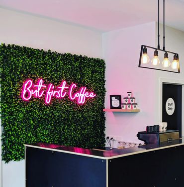 Coffee shop counter with neon sign.