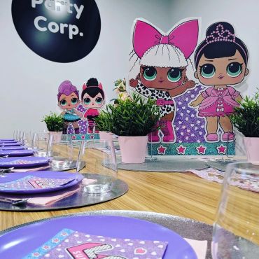 LOL Surprise themed party setup with decorations and tableware.