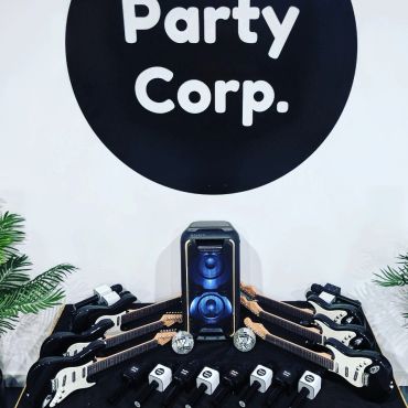 Party Corp setup with guitars and speakers.