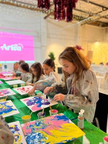 Children painting at an art event.