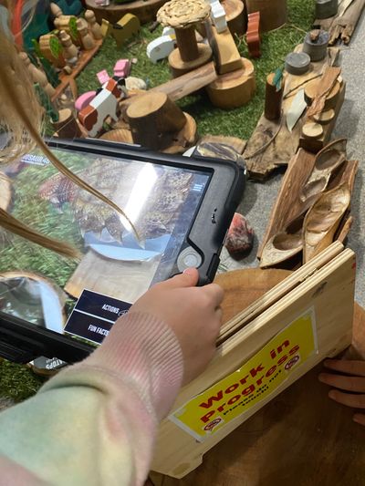Image of child holding iPad using Augmented Reality
