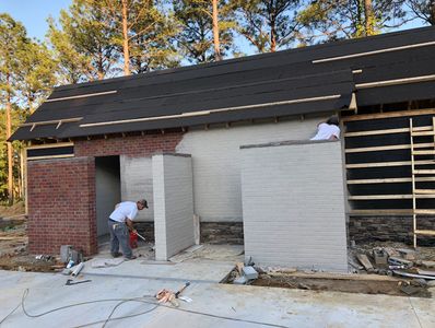 Commercial bathroom exterior brick being painted grey